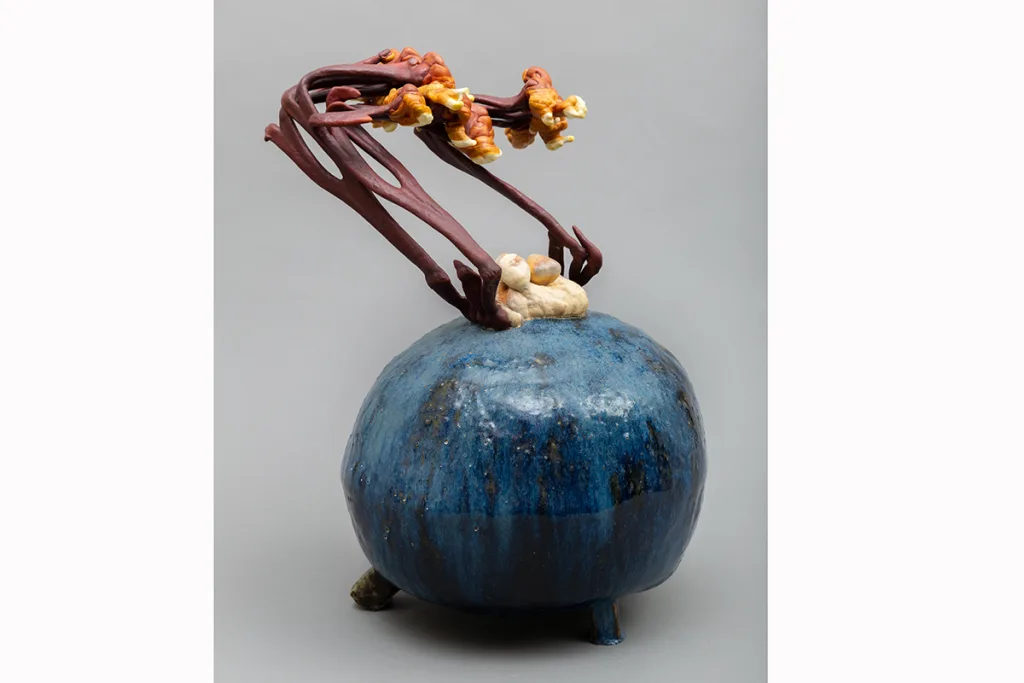 Image of a Sam Shoemaker piece featuring mushrooms sprouting out of a ceramic vessel
