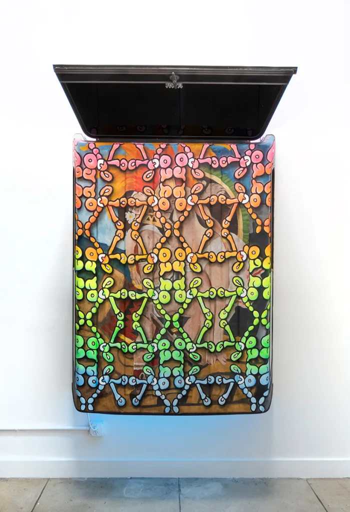 Image of an Ozzie Juarez piece, a brightly painted pickup truck camper top