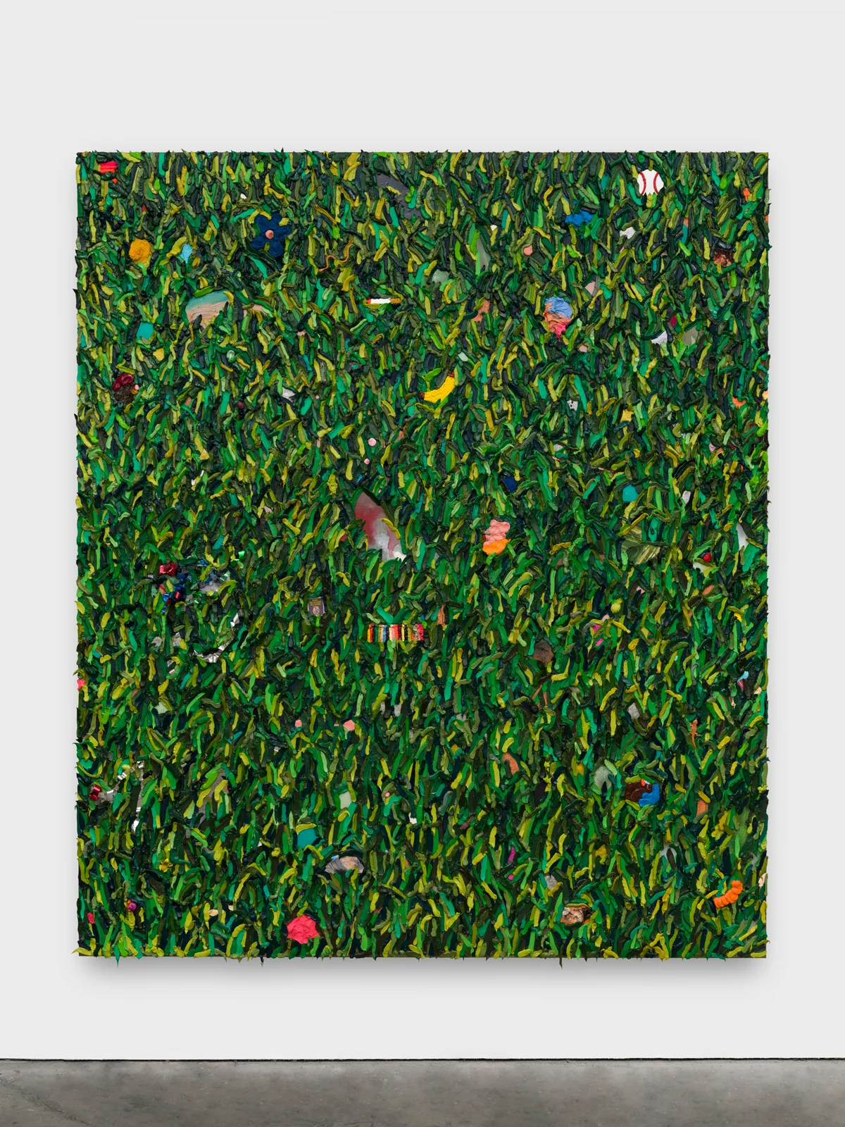 Layers of paint in various shades of green are applied to create a three-dimensional affect.