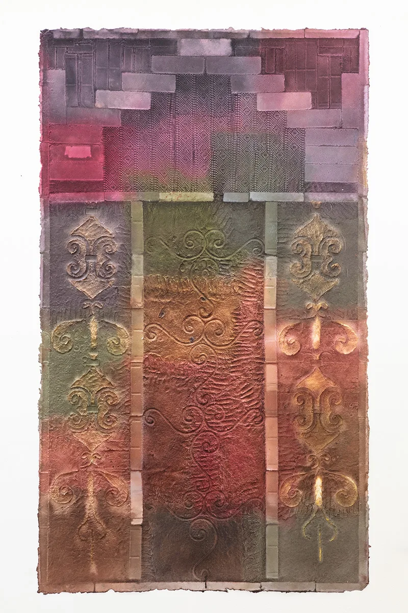 Multi colored handmade paper with brick and metal fencing patterns embossed on the surface.