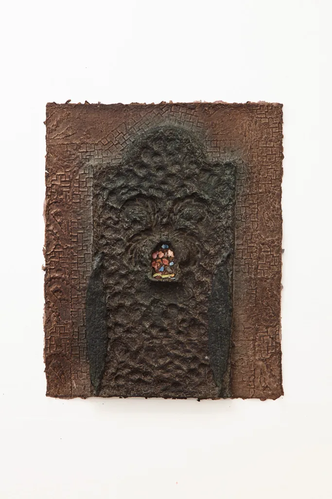 Green handmade dyed paper with an obscured figure/archway at the center