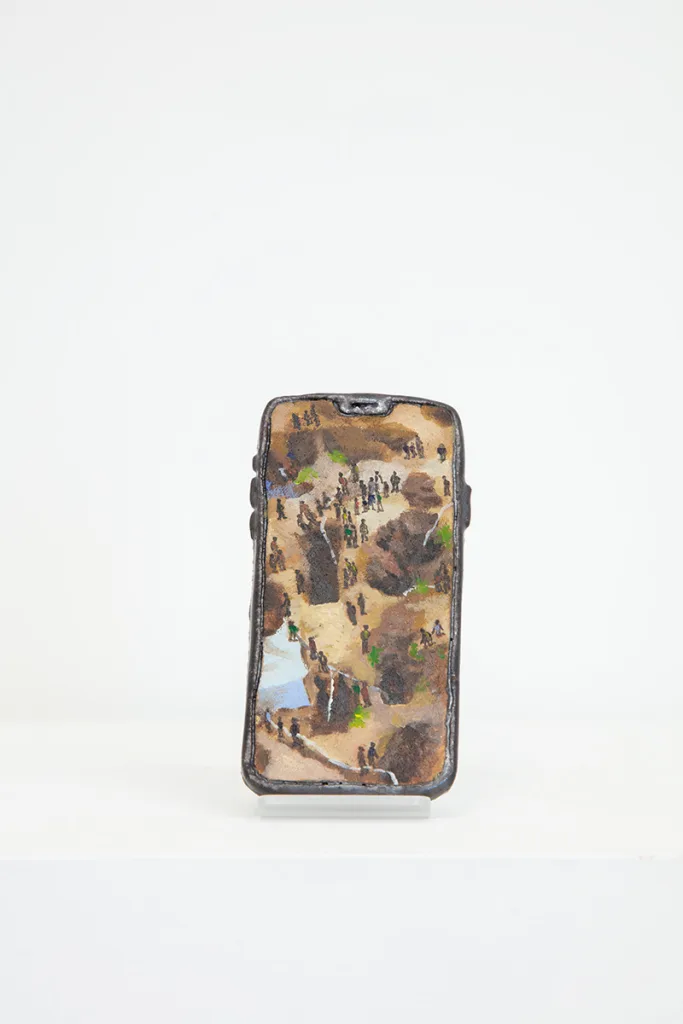 Image of Young Joo Lee’s Unknown Worker #14, a glazed ceramic iPhone with a portrait painted on its surface.