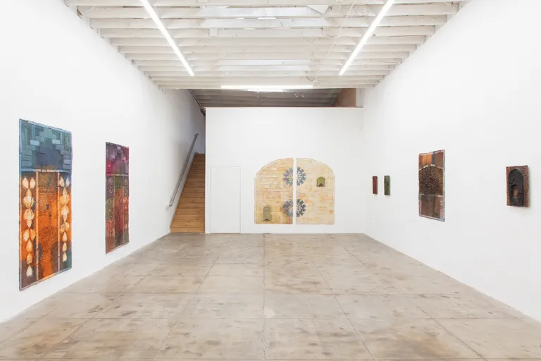 Installation image of Aryana Minai’s Does it Have a Heart, Does it Sing, Does it Sting? Containing various works on paper installed on the gallery wall.