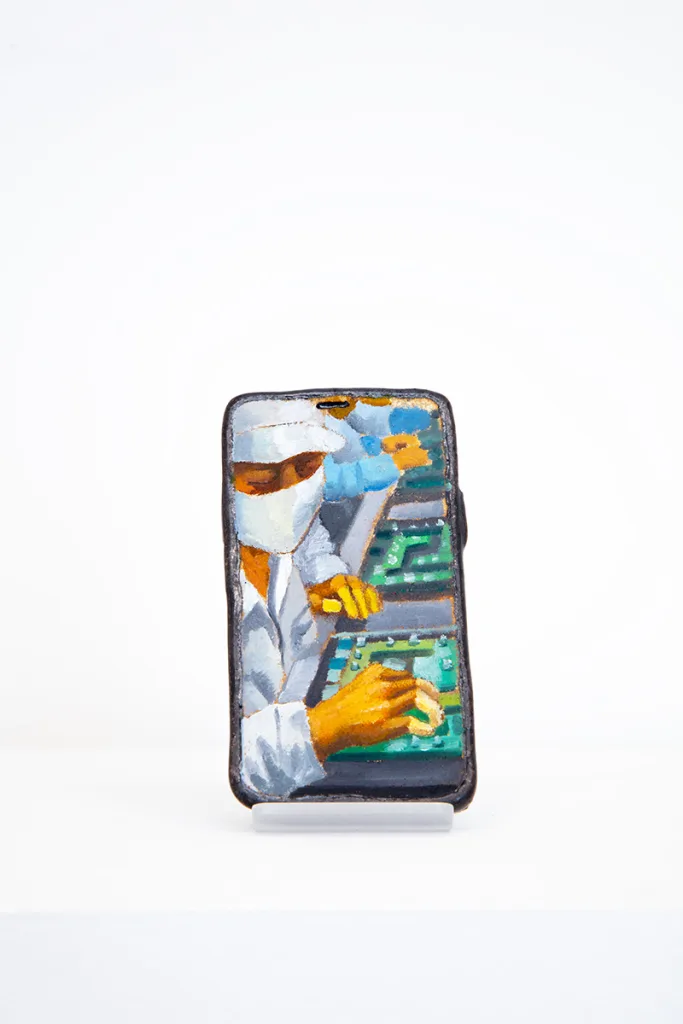 Image of Young Joo Lee’s Unknown Worker #9, a glazed ceramic iPhone with a portrait painted on its surface.