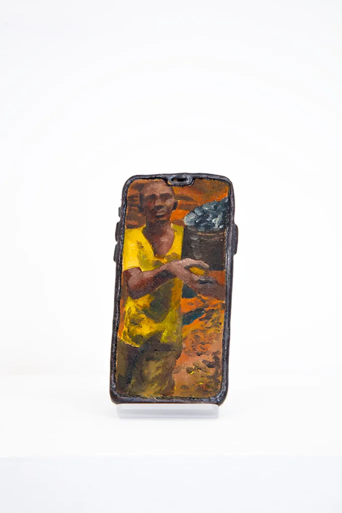 Image of Young Joo Lee’s Unknown Worker #13, a glazed ceramic iPhone with a portrait painted on its surface.