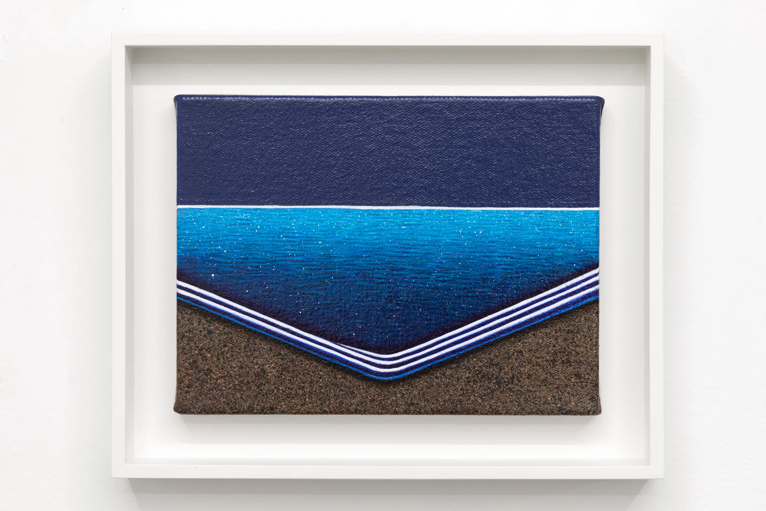 A painting of a body of water, a dark blue sky, and dark colored sand. The bottom half is made up of sand and waves while the top half is the horizon line and sky above. The body of water is shaped to have its corner closest to us