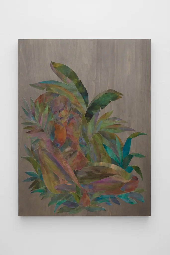 Ink on cut paper arranged to form a figure sitting upright with their legs crossed in a bed of foliage. Mounted on a wood panel with a dark gray stain