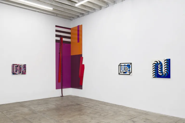Installation Image of Infinite Games showing the geometric abstract paintings, patterns are striped, grid style, 3D shapes and crescent shapes.