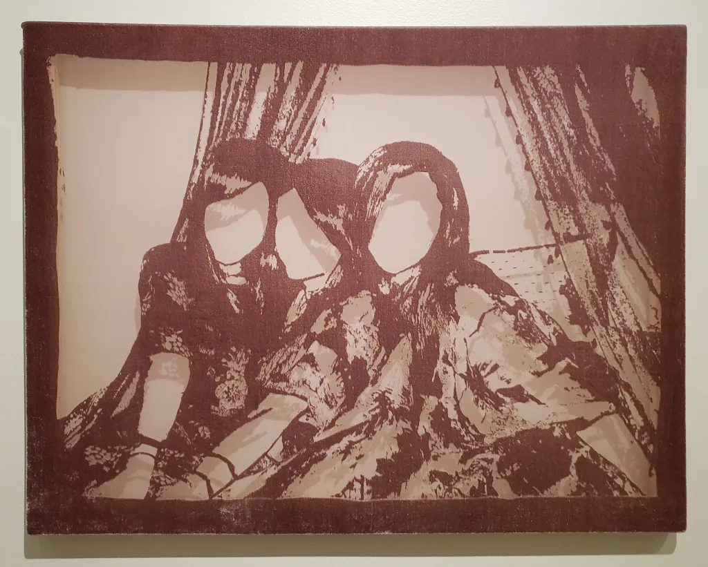 Three young women holding each other close