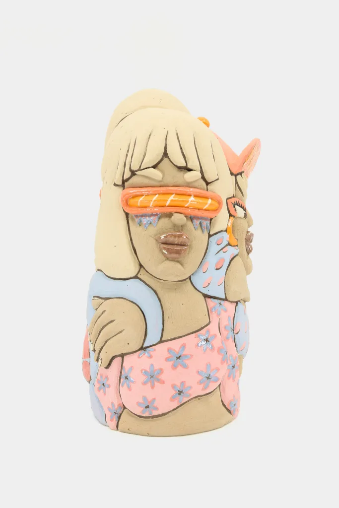 A carved and glazed ceramic vessel depicting a woman with retro futuristic sunglasses and the arm of a friend leaning on her shoulder.