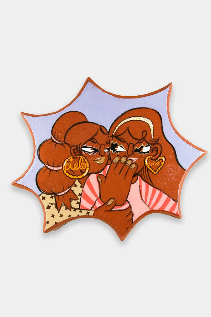 An amoeba shaped glazed ceramic wall-work depicting two women holding one another closely and whispering.