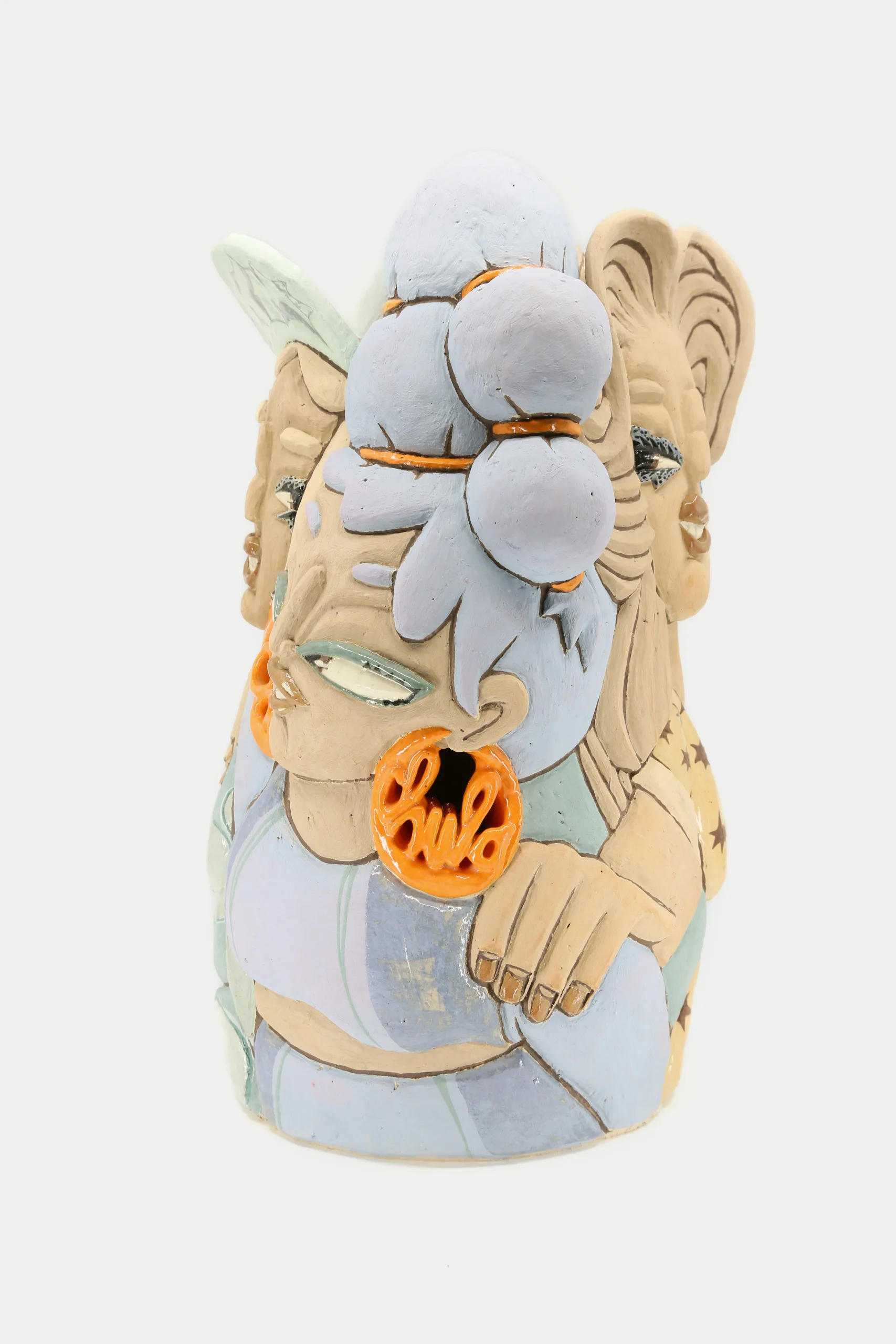 A carved and glazed ceramic vessel depicting a group of women. The three visible women are looking in different directions and are positioned with their profiles facing the viewer. The frontmost one has an orange earring that reads "Chula."