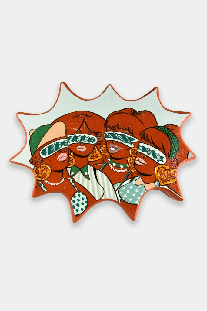 An amoeba shaped glazed ceramic wall-work depicting a group of four women, all wearing narrow futuristic sunglasses. They have red skin and hair and are in front of a light mint green background.
