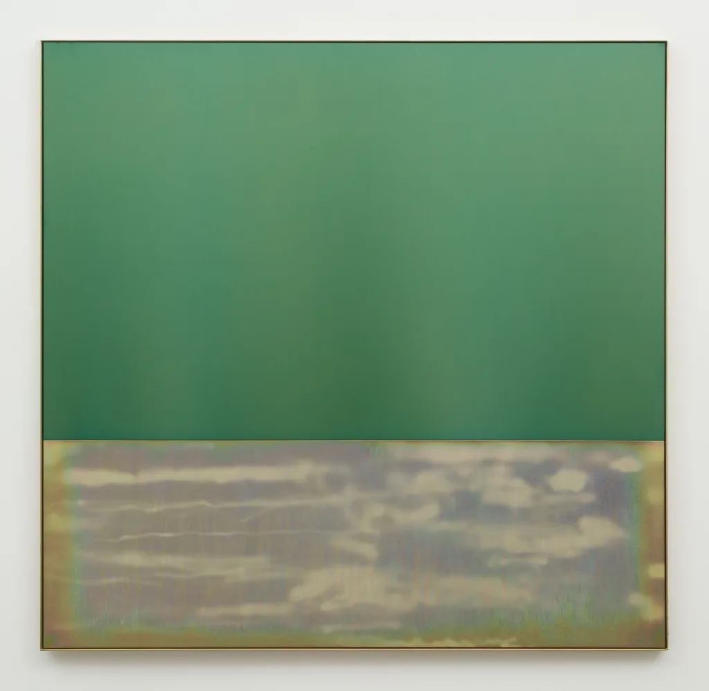 A flat, light green plate of anodized aluminum sits above a sandblasted plate of yellow zinc plated steel, within a frame of the same steel. The works overall dimension is almost square and the top plate is about twice the height of the bottom one. The yellow zinc plated steel below has horizontal cloud like sandblasting marks and the whole piece reflects ambient light.