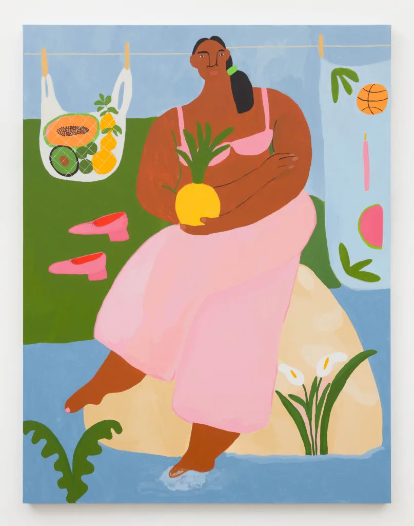 A painting of a woman holding a pineapple, wearing pink pants and a pink bra facing the viewer, sitting atop a light beige rock in a body of blue water. Her legs are crossed and her right foot is barely entering the water, making a slight splash. In the background, we see a clothesline hanging large bags of fruit.