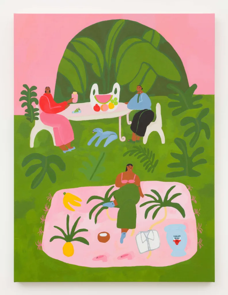A painting of three women lounging on a grassy field with a pink wall behind them. Two of the women are sitting at a table beside a dog enjoying fruits and a pink box of McDonald's french fries. The third woman is sitting on a picnic planket surrounded by fruit, shoes, a white button up shirt, and a Chicago Bulls vase. The pink wall in the background has a large arc shaped opening revealing more lush green foliage.