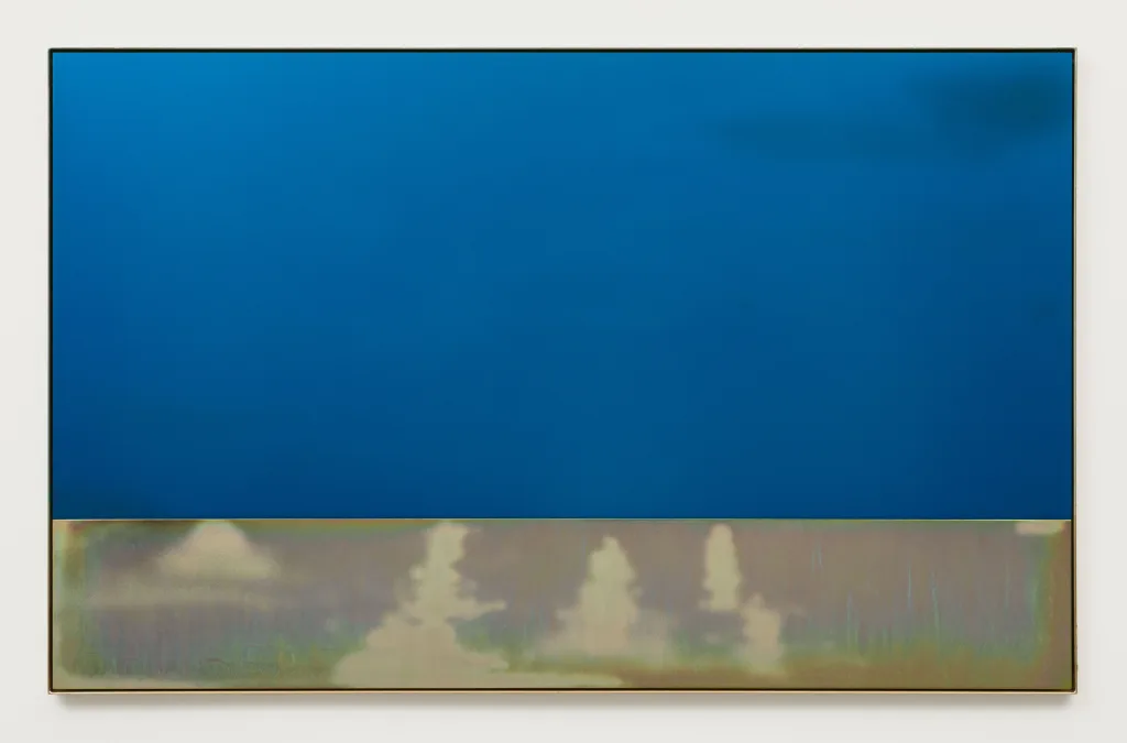 A clear blue anodized plate sits above a plate of yellow zinc plated steel with sporadic and expressive sandblasting marks. The two plates are framed in yellow zinc plated steel.